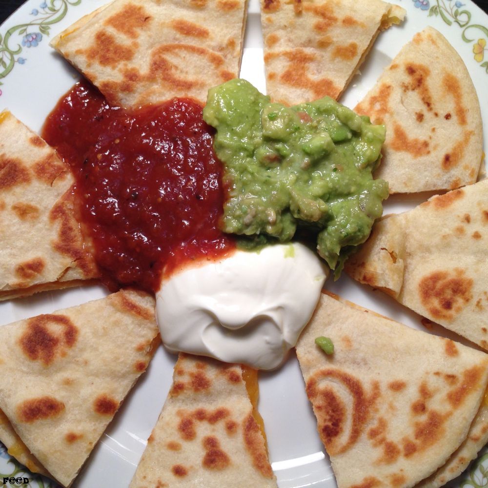 it is a quesadilla, flour wrapped, fried cheese, with guacamole, sour cream, and salsa, what is amazing is how things like this just sort of appear in front of me... sometimes, on a good day... after remarking on feeling the pangs of hunger