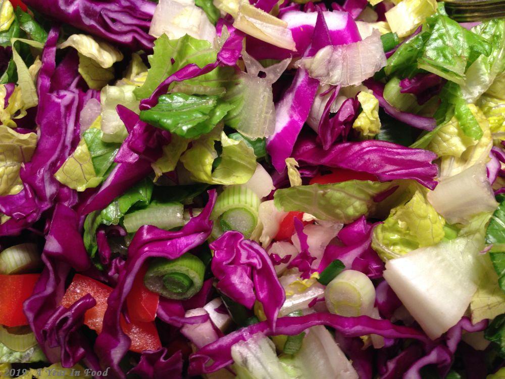 Lettuce, cabbage, green onions, red peppers.  These salads starting appearing, they are good, chopped lettuce, a few odds and ends, nothing really fancy, but then, salad does not have to be