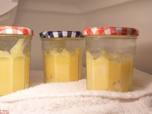 Jelly jars filled with custard, three, on towel, in top shelf in refrigerator, somewhere in California, USA, most of this info, not immediately apparent from the photo, or is it