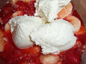 Almost a meal its so big, heaping bowl of frozen strawberries, recently thawed, bananas, and ice cream
