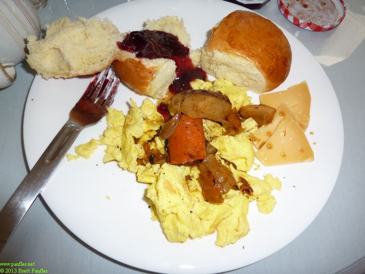 Eggs, hawaiian rolls with jelly, some type of cheese, same root sauce over the scrambled eggs
