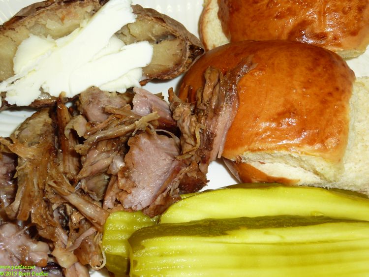 pulled pork sandwich, rolls, pickles, who knows what the white stuff is, ah, it says below, potatoes, so the white stuff is butter