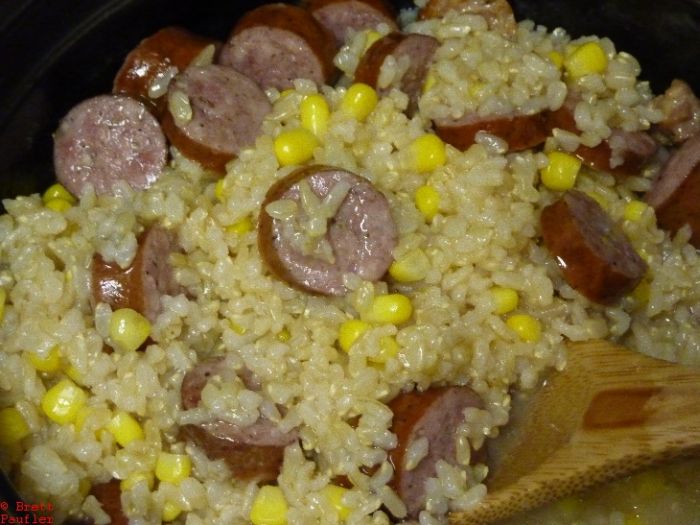 Cooked result, rice is done, water has thus disappeared, and its rice, corn, and sausage, good eating that