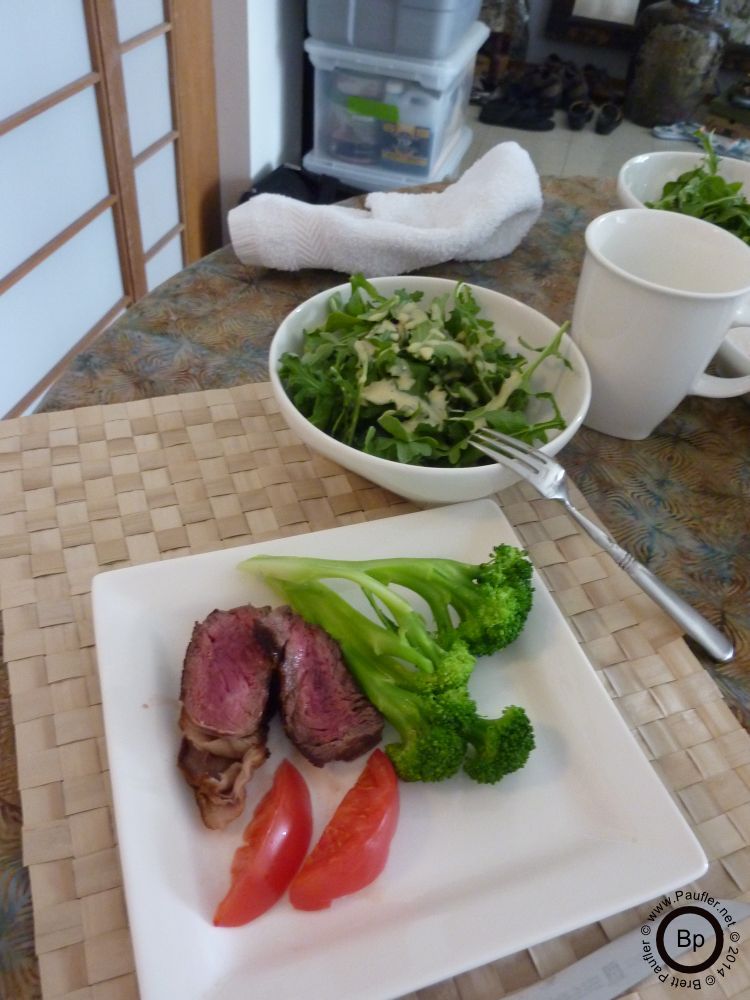 salad, broccoli, tomatoes, and steak