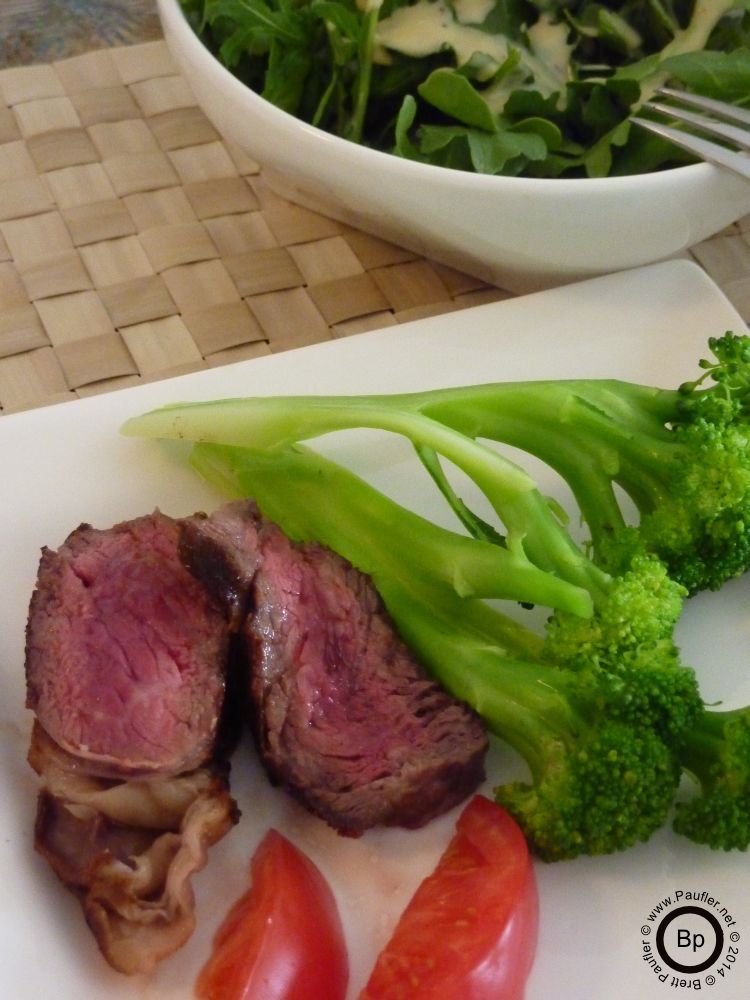 close up of steak on plate with vegetable condements