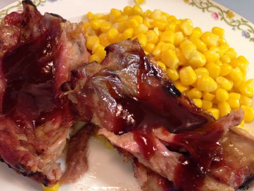 Ribs as served on the plate with BBQ sauce and a side of corn, do not know where that came from, very tasty, falling off the bone good
