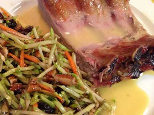 quarter rack of ribs on a plate served with broccoli slaw