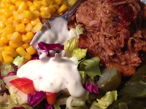 pulled pork, no bun, with a side of corn and a heavy ranch dressing salad