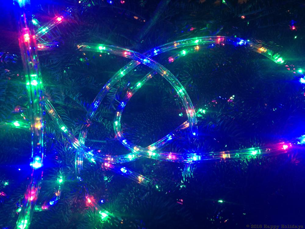 a close up of a christmas tree with lights, the strand was something like 150 feet long, it was nice to go overboard with the lights