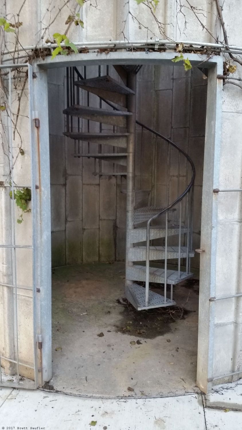 A converted silo with stairs leading up to a viewing platform overlooking the grasslands, it was a nice little effect, fun little near playground toy, that would appeal to older folks, this is the doorway, stairs in the background, odd how such a thing can be an adventurous obstacle, perhaps I need to get out more