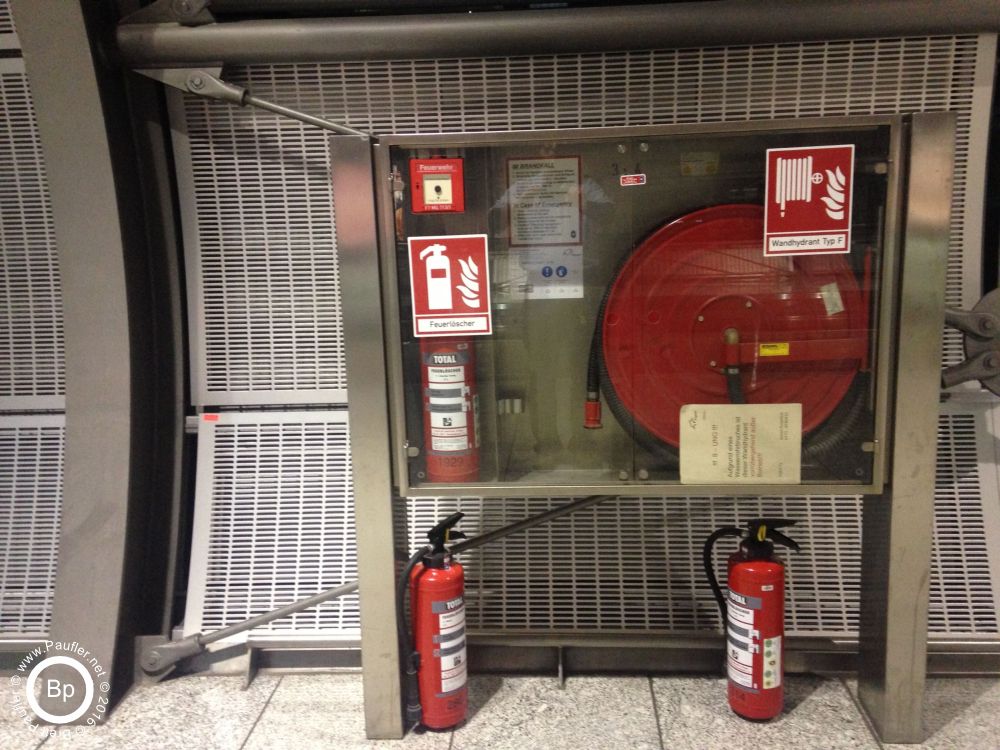 Fire extinguishers at the Frankfurt airport, not much to say about this, lots of extinguishers, fire hose and so on, the airport itself is a city unto itself, and all around is a tall fifty foot wall, secure area the lot, which doesnt explain how passive the security guards were when a drunk guy threw an empty bottle of wine down the hall, their job was to make sure he left, not that he didn not throw a bottle before he did, do not even think the elevator went much of anywhere, just out of their area of patrol, weird, just threw the bottle in the airport, not even a ticket