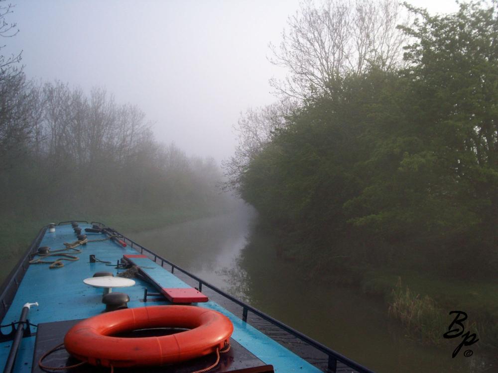 The blue topped rental barge is making a turn around a fog shrouded curve in the canal, it was very river like, fog in the morning, burning off, with near thunderstorm conditions later in the day, we hardly ever made it to the roof, preferring to shimmy along the edge, in the far front was a place to sit, which was nice during one of the mile long tunnels, yes, mile long tunnels, one of them might have been two miles long, truly incredible, the canal through the tunnel only had clearance for two boats passing each other plus a foot or so, amazingly, we sometimes passed by, maybe often passed by another boat, without a bump, on a long tunnel the light behind would fade before the light in front emerged, it very much was like the wild ride in Willie Wonka, down the chocolate river