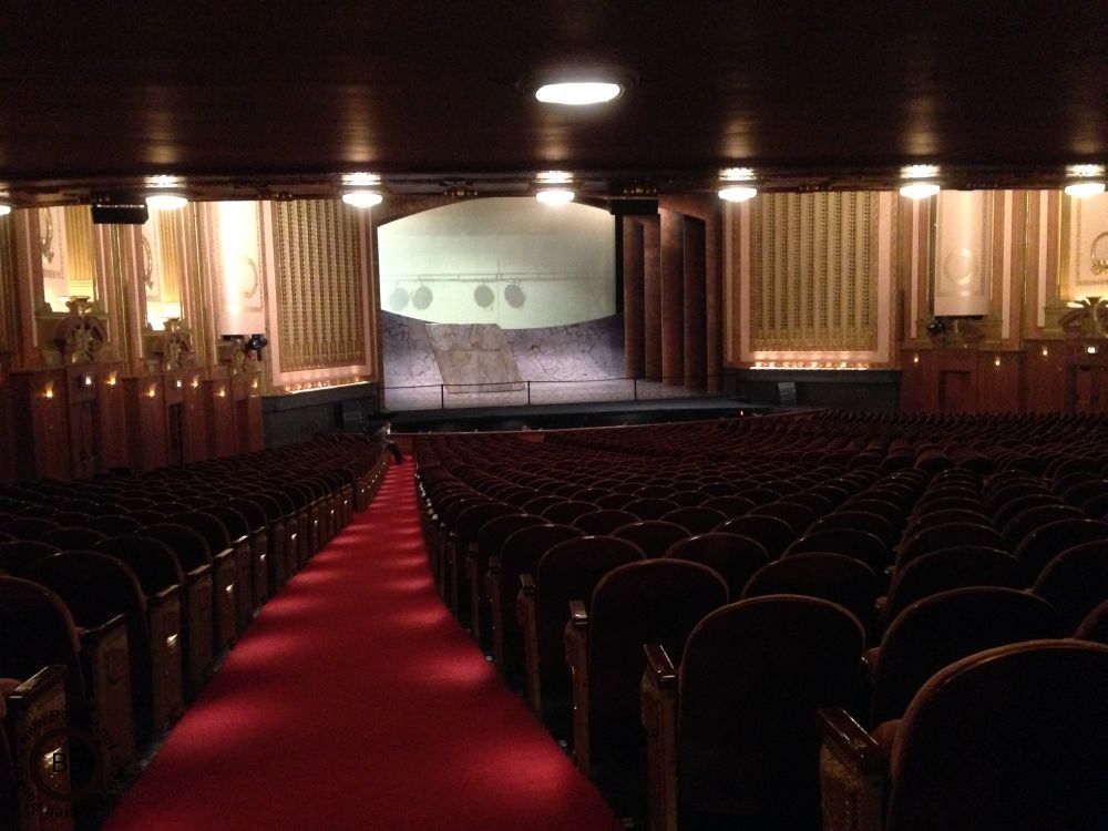 The main auditorium, viewed from the back of the room, call them the cheap seats, though the balcony might be those, row upon row of seats, actually, with the stage in front