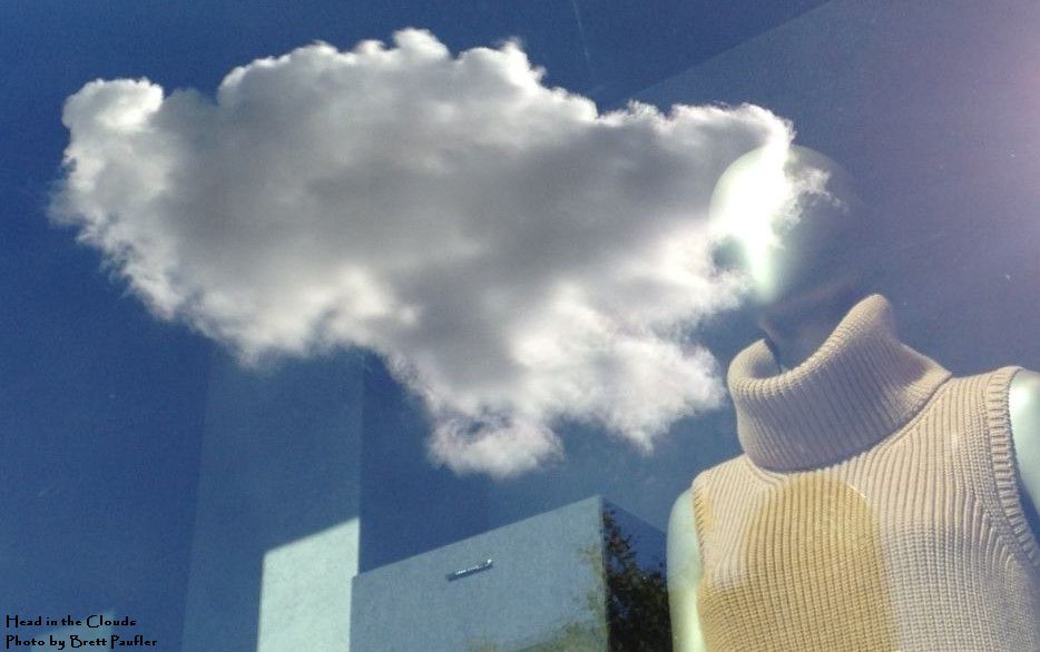 A mannequin, reflected in the window where the head might be is a cloud, passing by, hence the name