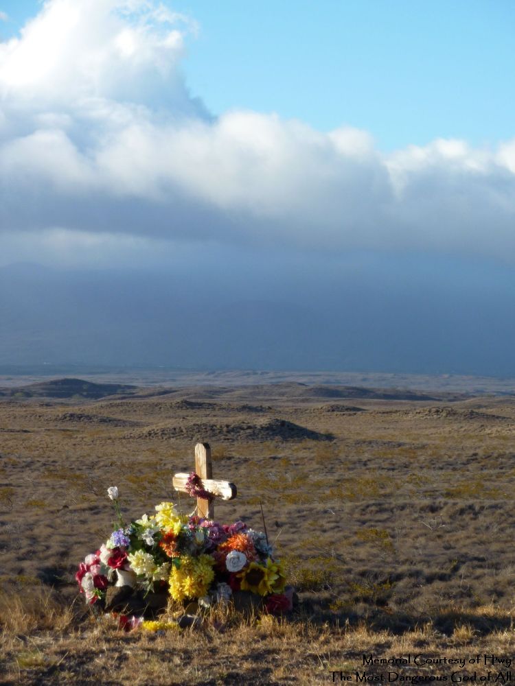 A roadside memorial, which I take to be to the God H'wy, opinions on this will differ, and I am sure the original participants had other(s) in mind, flowers, cross, rolling hills, and a blue sky, a nice view for the here-after