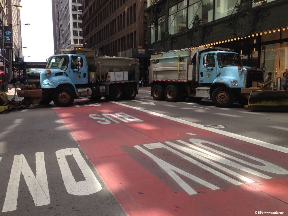 Snow plows parked to block the street, no one is driving by, actually, quite good terrorist control, would be hard to get past, to plow down folks on the street, not that I thought of that at the time, I just like the image, the shadows, the writing on the street, one way