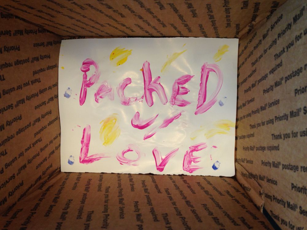 Another, two sided finger painting lined the bottom of the box, this one reading Packed w Love, both having hearts or something close to hearts painted on the opposite side
