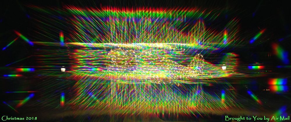 A Christmas Light Display in the shape of an airplane as seen through the prismatic glasses that they were handing out during the lighting ceremony