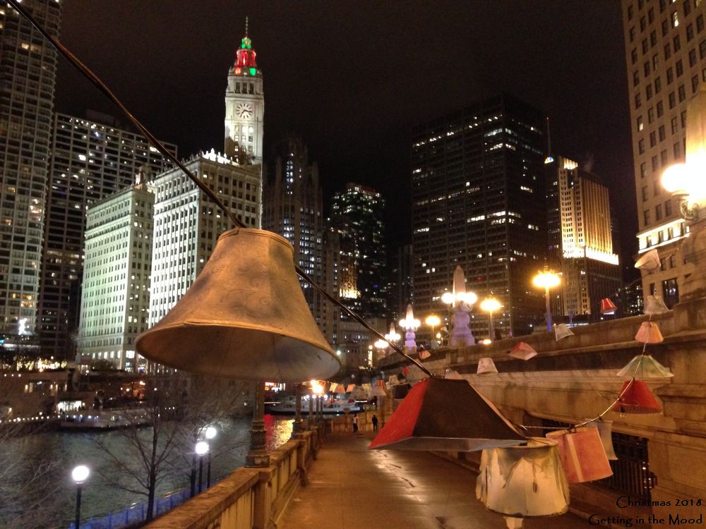 This was taken on the River Walk, Chicago River, showing lanterns arranged all nicely, one lantern in the near foreground, a line trailing back, and I think that is the wrigley building behind it all, the river to the side