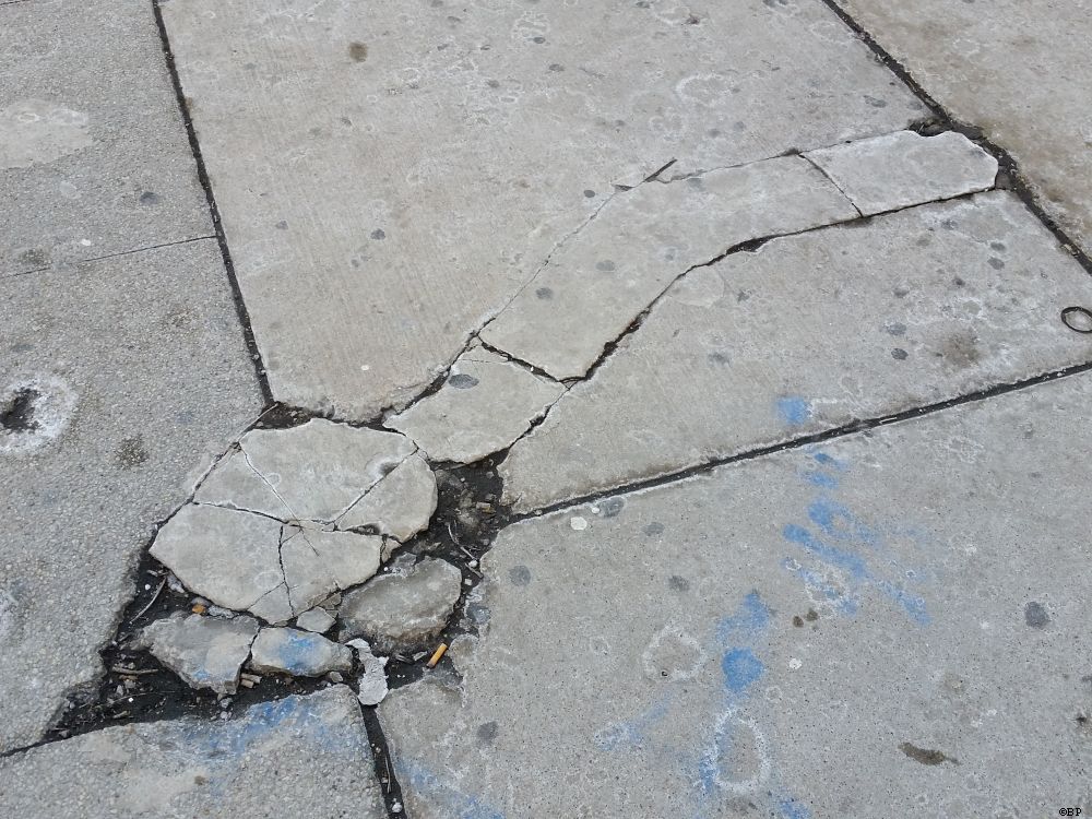 Cracks in concrete, probably where repair work was done, forming a sort of arrow