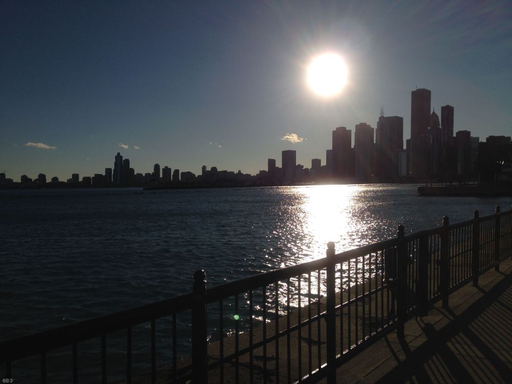 Sun Going Down, well, sort of, it is still in the sky, likely winter, over the city, Navy Pier, Chicago in the background, nice shadowed out effect from the bright sun