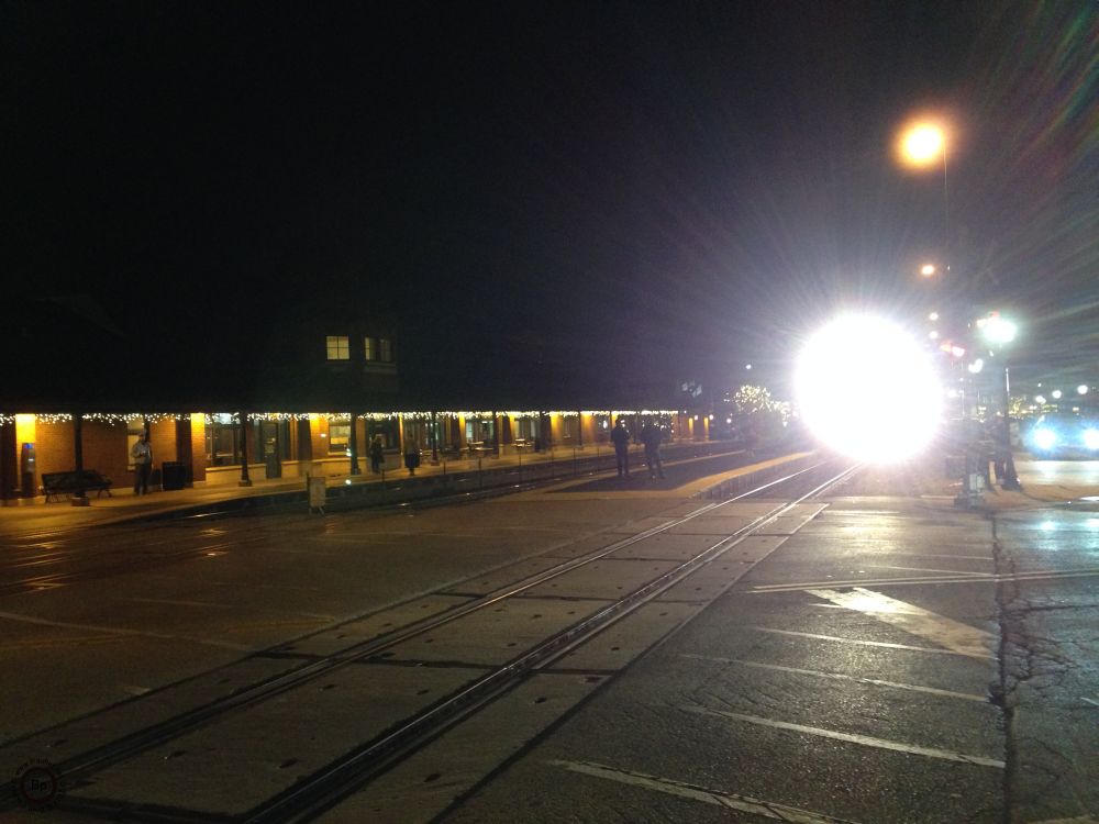 Arlington Heights train station at night with a train pulling in