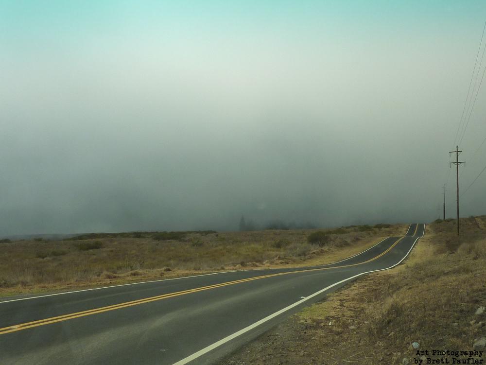 This project has quickly become a post anything and everything project, which is fine, I have quite the backlog of unused photographs, which need a home, this is of the Upper Road to Hawi, I believe, on the Big Island of Hawaii on a foggy day, keeping in mind a foggy day here, may well have been quite sunny elsewheres, there is grass and rolling hills, a nice country road, very pleasant, a nice moment in time... I fear I was mistaken as to the locale, now that I examine the image, we have a desert landscape, so this was the Upper Road to Hilo, yes and that is what the original image name relates, Saddle Road to Hilo