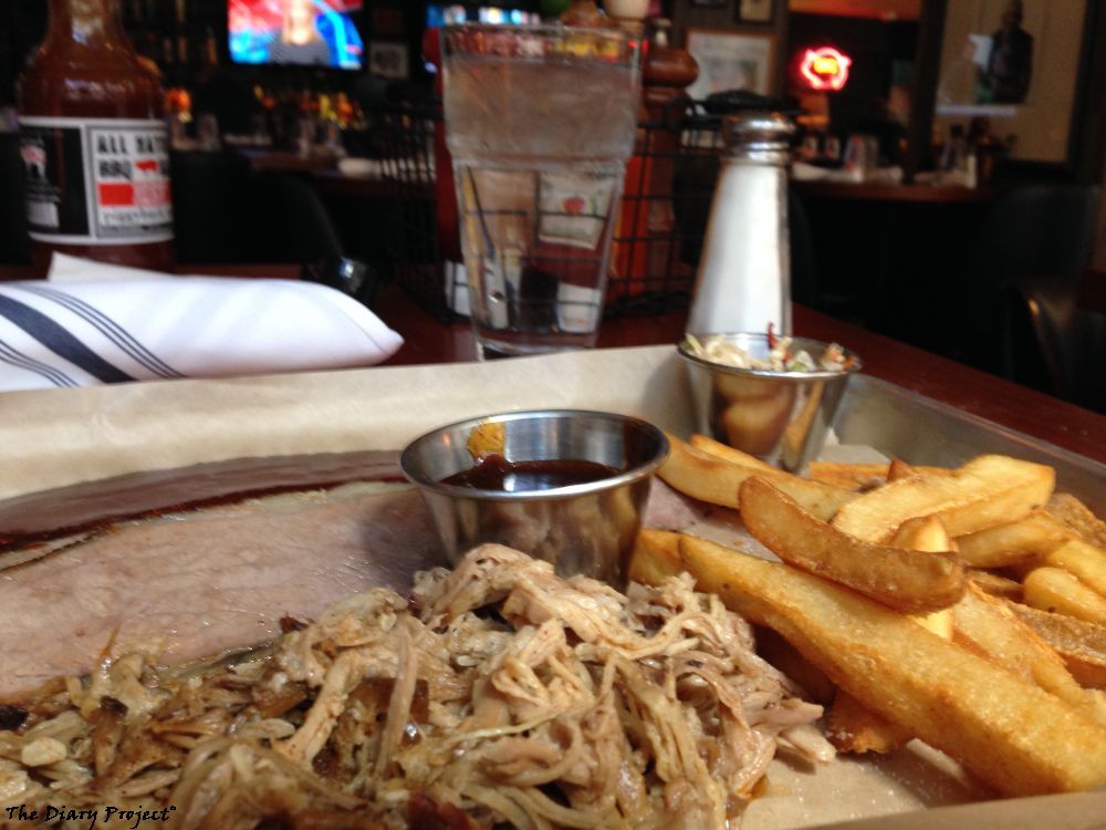 Beef Brisket, pulled pork, barbeque sauce, french fries, cole slaw, all on a traditional steel platter, salt for the fries, water to drink, it would be nice to be a drinker in many ways, beer, wine, whiskey, whatever, but I am not, so the endless options in this regard are lost on me