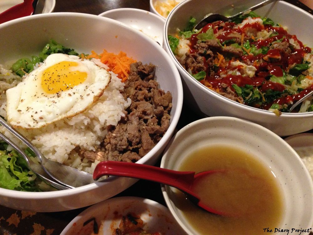 Two nice bowls of Korean food, rice meat, lots of vegetables, with the side dishes mixed in and to the side, oh, and along with soup, quite the mid-day bargain