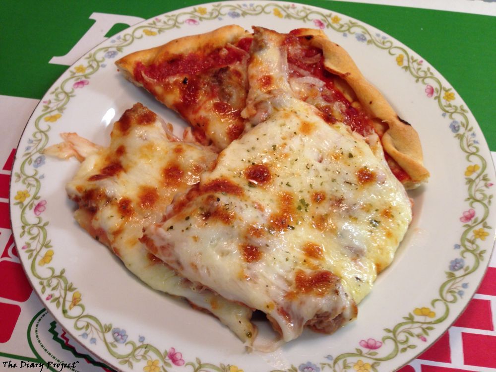 A plate of pizza, all piled up, looking  nice and goey, the pizza box forming the background, I was not happy with the first bite, but it grew on me, during the leftover phase, which lasted quite a while for this one, so either more restraint, or easier to restrain