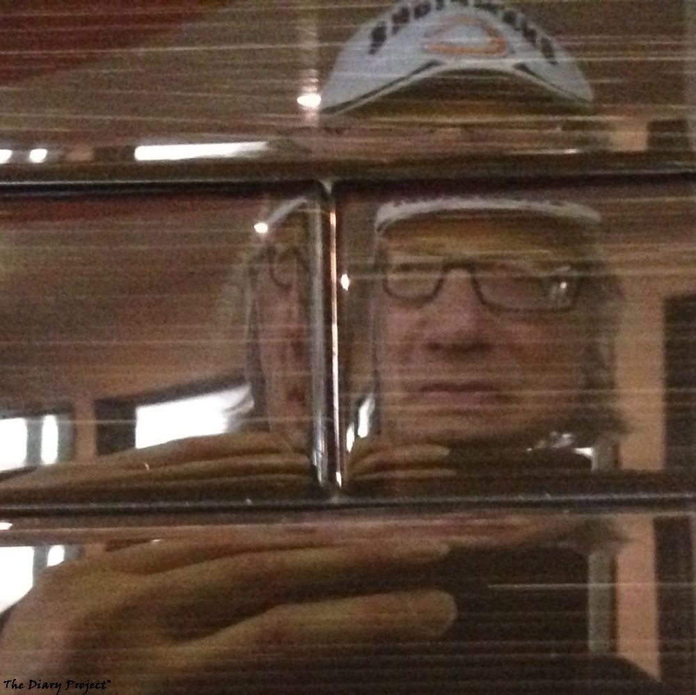 Self portrait as shot in reflective glass bricks