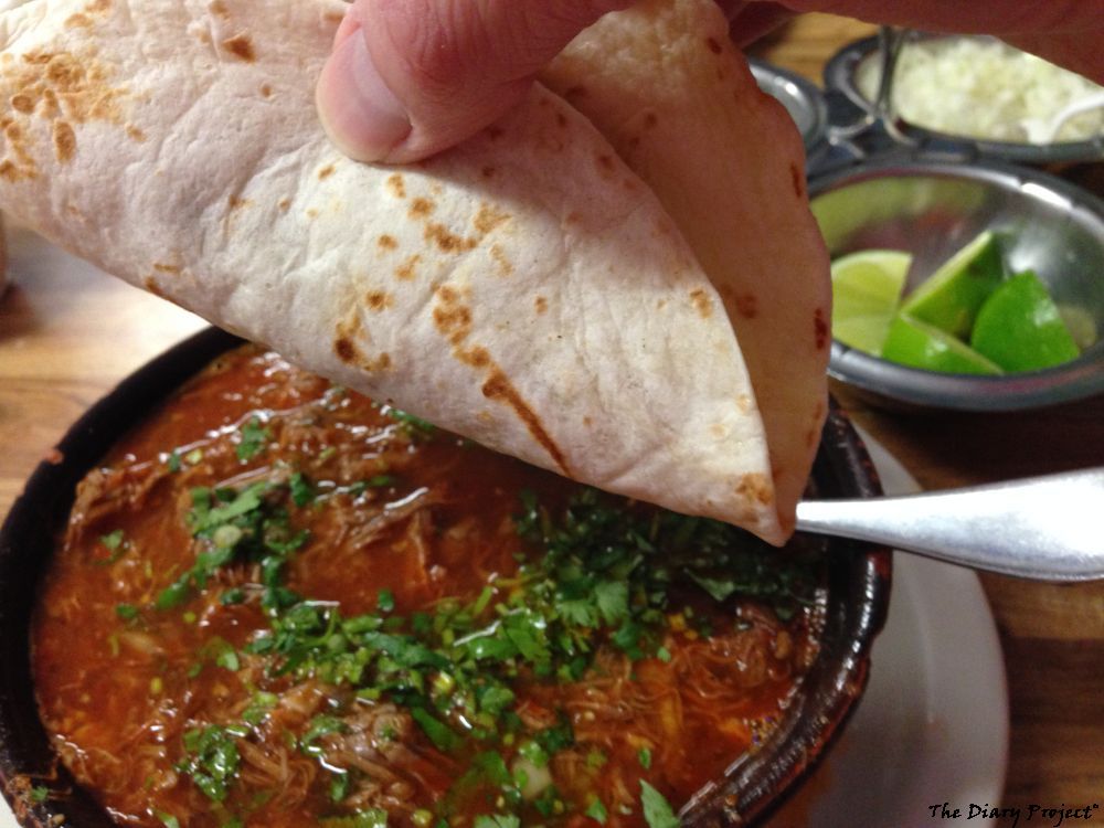 add cilantro, onions, and a freshly squeezed lime to the goat stew, spoon up heaping helping of meat, let juice drain out of flour tortilla, eat, say ah, repeat, say ah, repeat again, OK, I'm  just going to lick the bowl, now