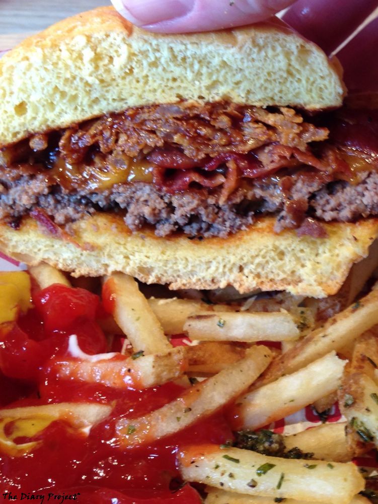 A Bacon burger with cheddar cheese and lots of onion rings, the onion rings where crisp and fine enough to work as a fine bacon extender and did not even notice they were not bacon at the time, so good job on their part, fries flavoured with herbs, served in a basket with lots of ketchup and a hint of mustard, this was a satisfying meal