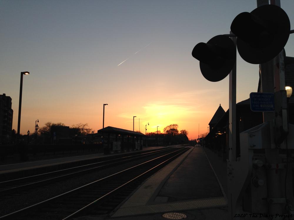 Train station at sunset, the lower half of the picture shaded out, colorful sky, crossing guard to the right, tracks drifting off into the sunset and whatever metaphor that image alludes, the reflected sky shining on the tracks is one of the most pleasing parts... after one has stared at the image for awhile