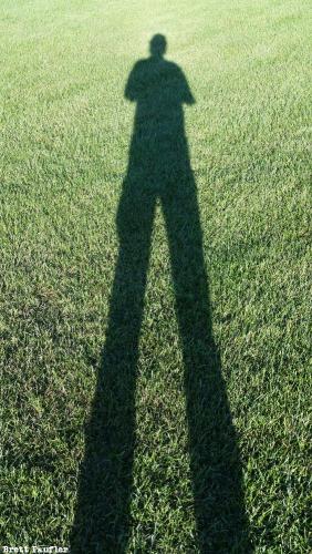 Full Length Shot of myself in shadow with manicured grass as the background