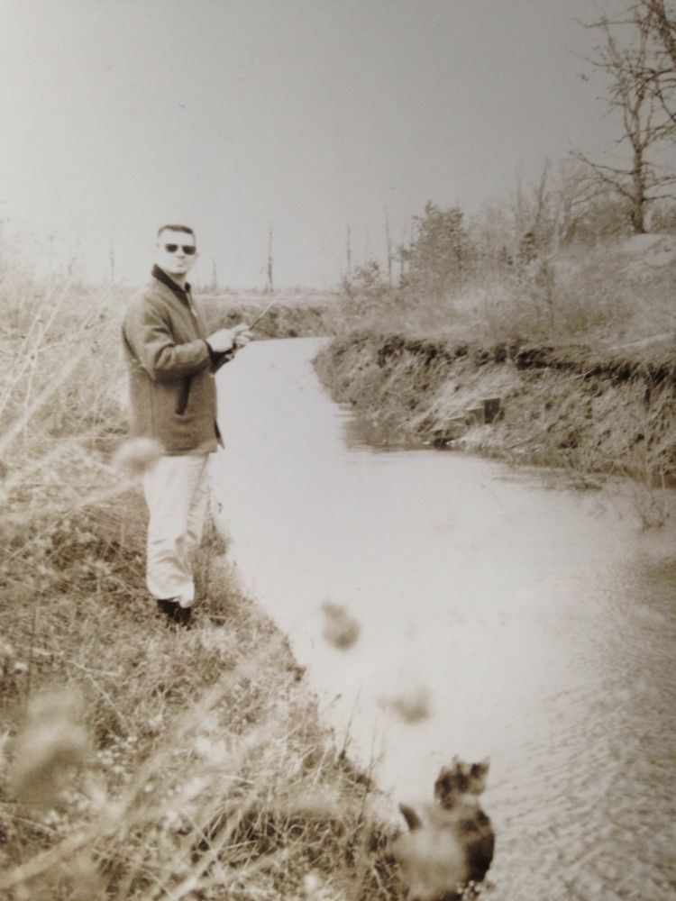 dad and a dog in black and white fishing at an unknown bend in the river, stream, too deep wide to cross, but not much of an obstacle if one needed to get to the other side, just a matter of getting wet, I was not there