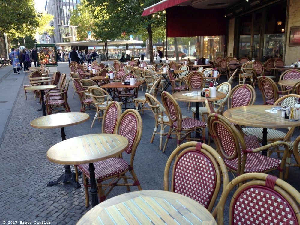 Berlin Cafe in the bright of day, all empty, same cafe filled up after a marathon, I recall a runner wrapped in a plastic sheet, sitting there