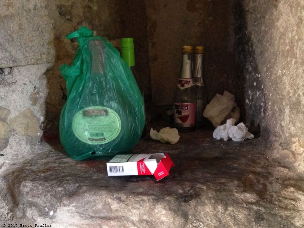 Alcove in the ramparts where kids or folks or tourists or locals would go and smoke and drink and who knows what else and here be their garbage