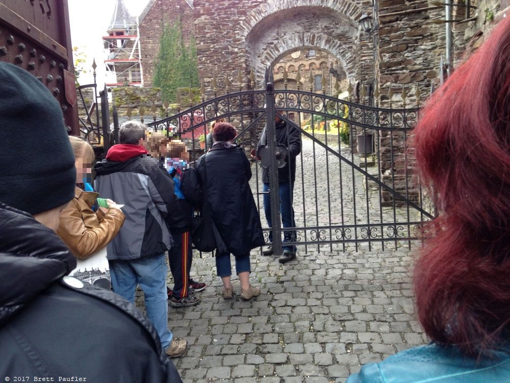 Waiting to get into a castle, everyone lined up, like a scene out of Willie Wonka and the Chocolate Factory