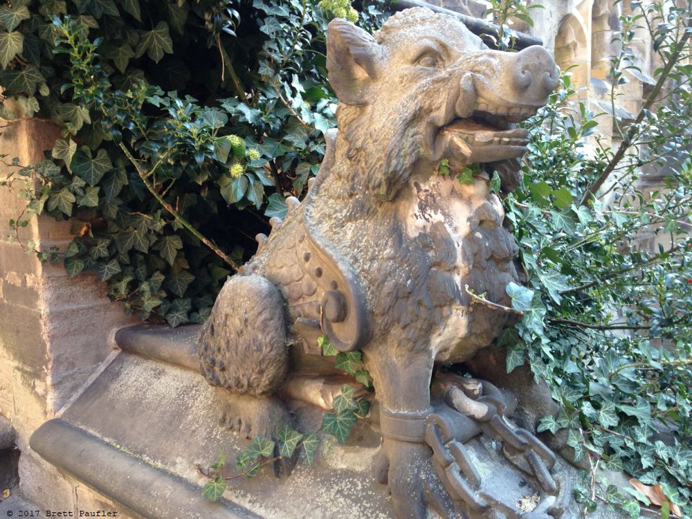 a statue of a hog or a pig, something alone those lines, guarding a staircase