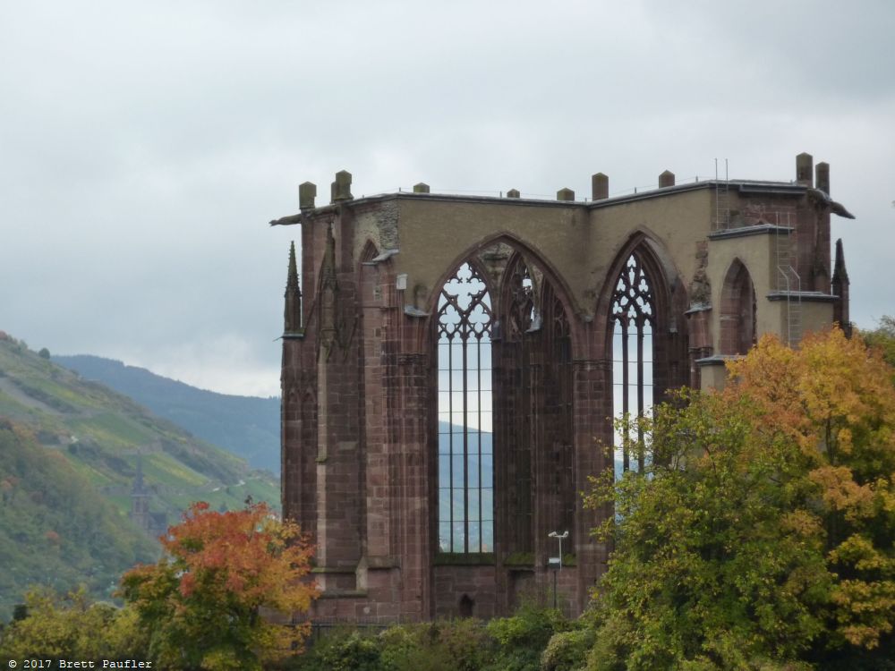 Close up of the ruins, main walls of the santuary going up several stories, reddish, empty, rain coming in from above, grass for a floor, it was all gated up, likely was not a mere twenty years ago, but you know, times change