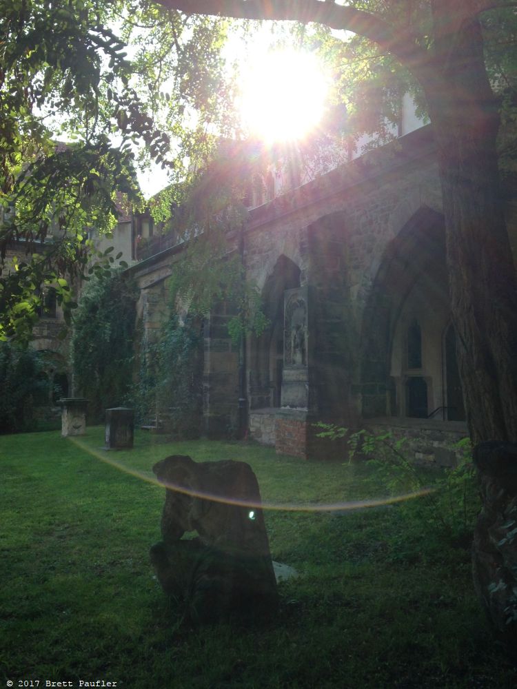 The light hit the camera lens just right in this one, the sun making a starburst display, church walls lining a courtyard wiht tombs and whatnot in the foreground, a good artsy picture that thousands have taken before