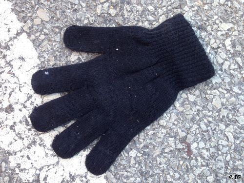 black knit glove, next to white line in streat