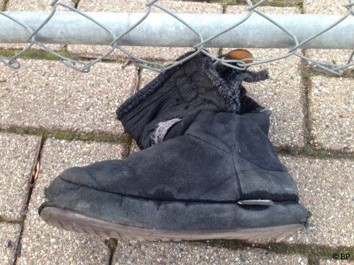 black boot, real beat up, probably from snow plow, no doubt a childs, lost when getting in the car