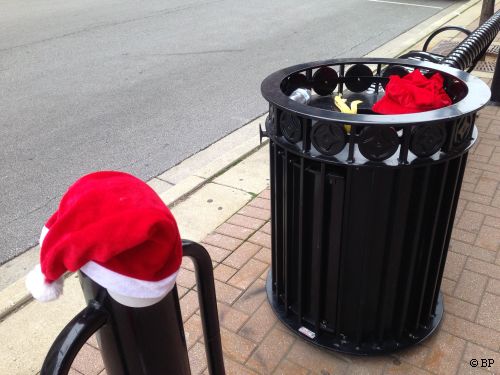 There was a Santa Run with thousands, perhaps tens of thousands, participants, eh, probably only a few thousand, anyway, with entry included a santas outfit, after the race, a few could be found on the ground, here, a pair of hats ona  post and sitting on a garbage can