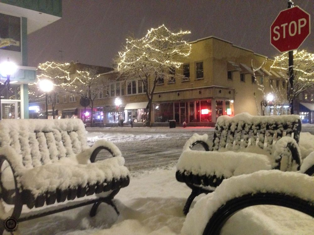 downtown sitting area with park benches in the snow