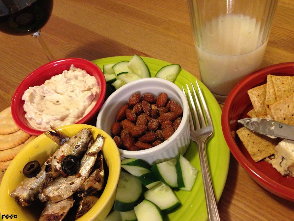 Starting from the upper left, going clockwise, spiralling towards the center, we have red wine, clam juice, which is oddly tasty in small portions, crackers and cheese, cucumbers, spiced sardines from can, clam dip, don't ask me the recipe, more cucumbers, and almonds, quite the feast after deciding to eat sardines, someone got carried away