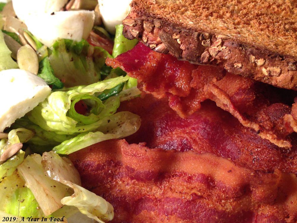 A BLT with lots of bacon and the BL part on the side, nicely browned whole wheat toast
