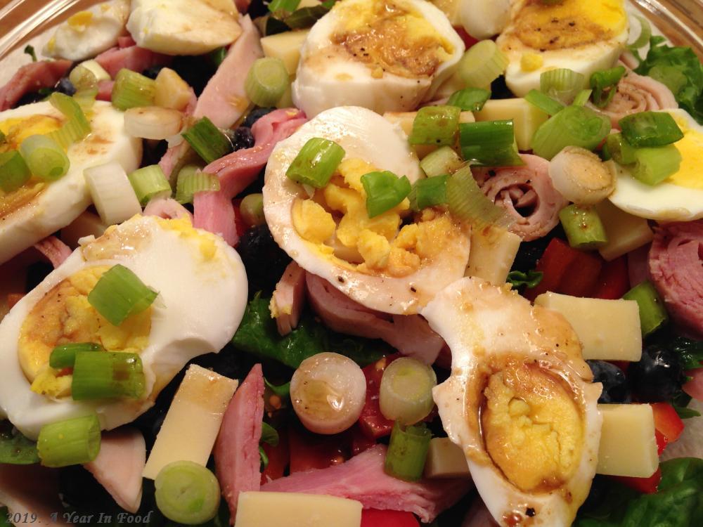 A chef Salad, complete with eggs, greens, blueberries, sandwich meat, scallions, red peppers, and tomatos, it was good stuff