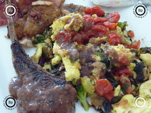 left over lamb chop, most likely, with scrambled eggs, brocolli, tomatoes, all sorts of stuff